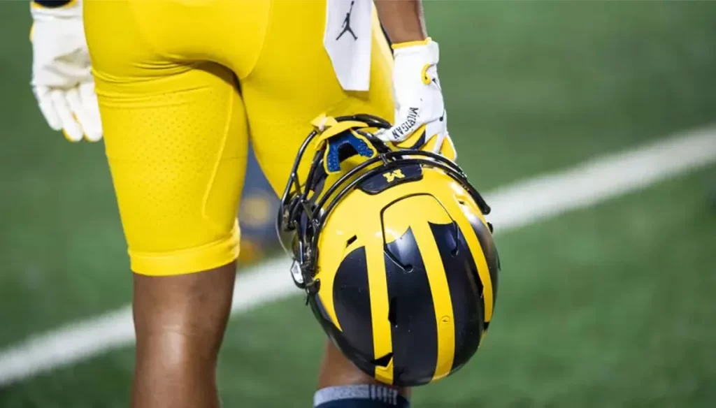 bhl-football-close-up-of-athlete-holding-u-m-helmet